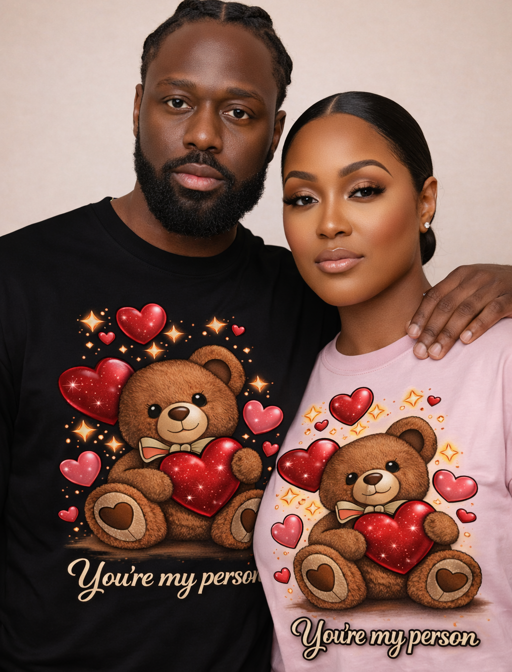 Man and woman wearing shirts with teddy bear graphics and text.