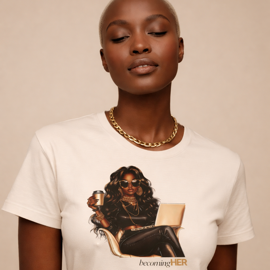 Model styling a beige Becoming HER graphic t-shirt with a gold chain necklace.