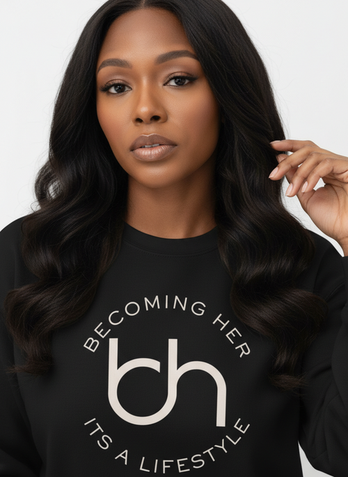 Woman wearing a black sweatshirt with 'Becoming Her' logo and text on a white background